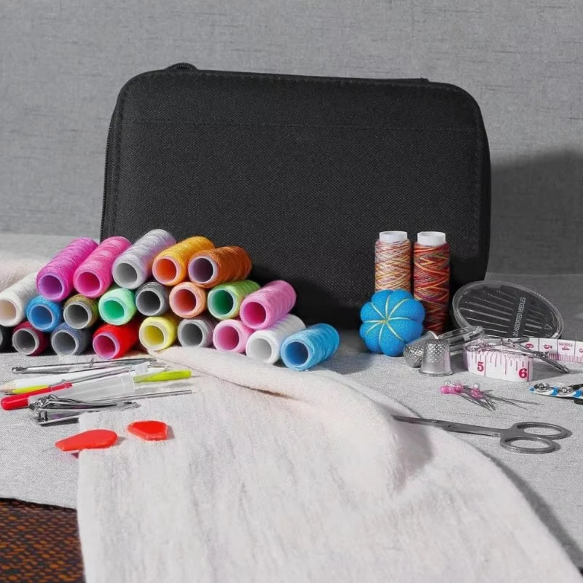 Spools and accessories laid out beside black carry case