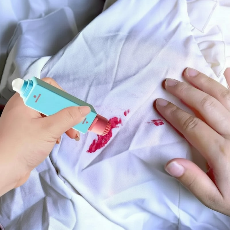 Stain remover pen cleaning a fresh stain on white fabric