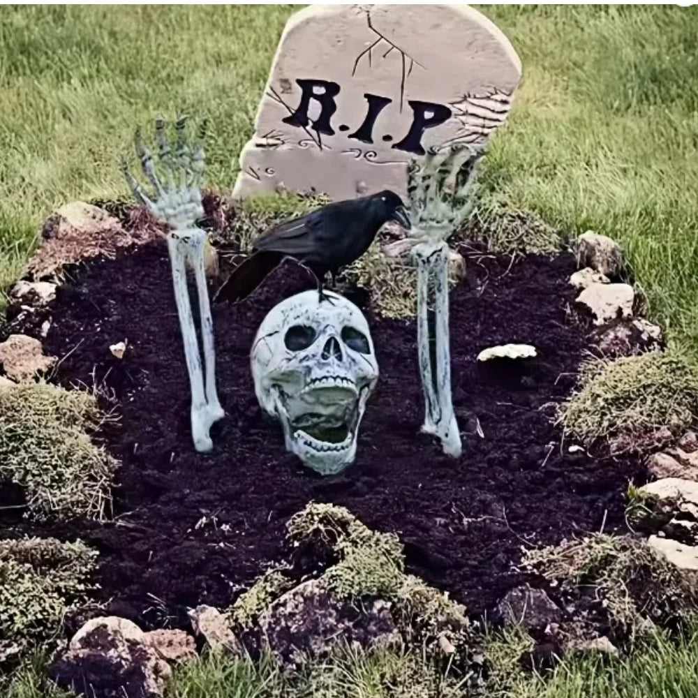 Grave scene with skull between two raised hands